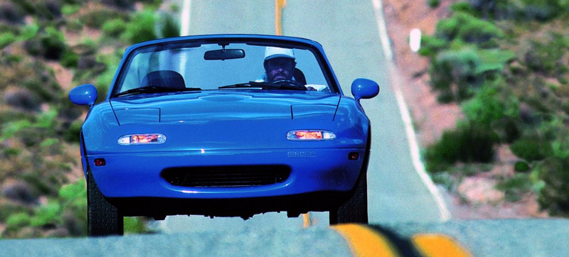 A Miata driver who’s partially wisened up to the slow march of UV rays, time and woe. Photo credit: Mazda